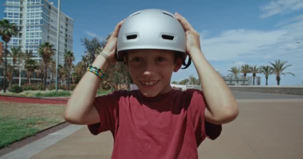 Adorable Funny Kid Look Camera Put Protective Safety Skateboarding Helmet — Vídeo de Stock