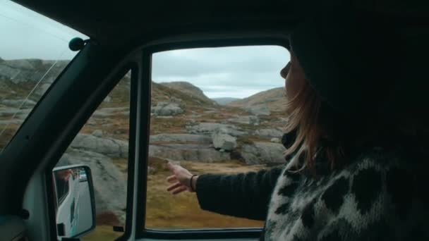 在野营车或汽车的乘客座位上手握妇女的照片 把手伸出窗外 用手指挡风 自由感和游手好闲的冒险挪威的电影路途旅行 — 图库视频影像