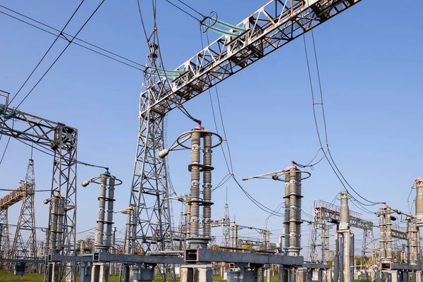 Stock image A high-voltage power electrical substation. Power lines, poles, ceramic and glass insulators, lightning arresters, sulfur hexafluoride circuit breakers, current transformers.