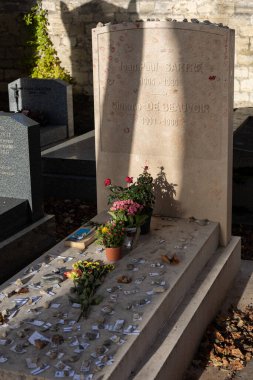 A grave of Jean-Paul Sartre and Simone de Beauvoir on Montparnasse Cemetery, Paris, France. A famous couple, was of the most influential and controversial writers and thinkers of the 20th century clipart