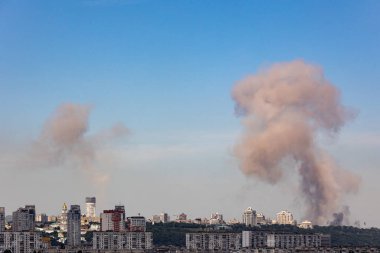 Kyiv, Ukraine - July 08 2024: Smoke rises over the city skyline after Russian combined missile strike to the civilian infrastructure of the capital city of Ukraine. Russian war aggression in Ukraine clipart