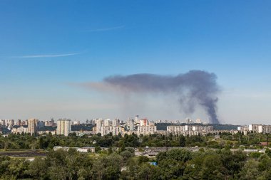 Kyiv, Ukraine - July 08 2024: Smoke rises over the city skyline after Russian combined missile strike to the civilian infrastructure of the capital city of Ukraine. Russian war aggression in Ukraine clipart