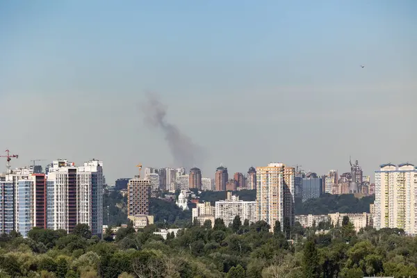 stock image Kyiv, Ukraine - July 08 2024: Smoke rises over the city skyline after Russian combined missile strike to the civilian infrastructure of the capital city of Ukraine. Russian war aggression in Ukraine