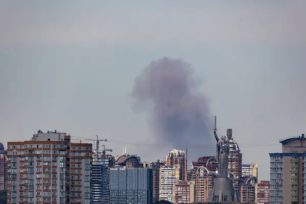 stock image Kyiv, Ukraine - July 08 2024: Smoke rises over the city skyline after Russian combined missile strike to the civilian infrastructure of the capital city of Ukraine. Russian war aggression in Ukraine