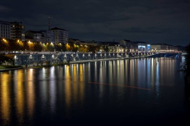 Torino, İtalya - 08 Kasım 2021: Ponte Umberto I köprüsünden gelen renkli yansımalarla Po Nehri seti gece görüşü