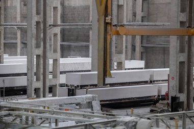 Havalandırılmış beton bloklar, AAC blokları (Otoklavize havalandırmalı beton), Fly ash veya Grey Cement Fly Ash Bricks endüstriyel üretimi. Bir otoklavda işlendikten sonra kesme blokları olan arabalar tedavi edilir.