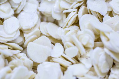 İnce buz kaplamalı, dondurulmuş sarımsaklı sarımsak dilimine yakın çekim. Süpermarketlerde raf ömrünün uzatılması ve bozulabilir hasat kalitesinin korunması için perakende paketlemeye hazırlar..