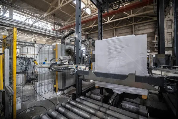 Havalandırmalı beton bloklar, AAC blokları (Otoklavize havalandırmalı beton), Gri Çimento Uçan Kül Tuğlaları endüstriyel üretim. Tamamlanmış ürünler ahşap paletlere yığılır ve plastik ambalaja konur..