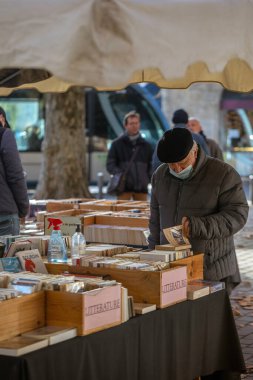Bordeaux, Fransa - 23 Kasım 2021: Jean Moulin Meydanı 'ndaki açık hava kitap pazarı, insanların kitap baktığı bir sonbahar ağacı ve arka planda bir heykel. Bordeaux, Gironde, Yeni Aquitaine, Fransa.