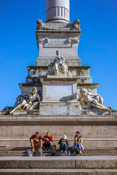 Bordeaux, Fransa - 23 Kasım 2021: İnsanlar Quinconces Meydanı 'ndaki sıcak sonbahar güneşli Weahter Anıtı ve Fontaine du Char du Triomphe de la Concorde yakınlarında dinleniyor.