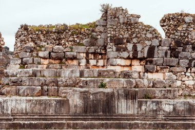 Ancient stone ruins in rural countryside with grassy landscape