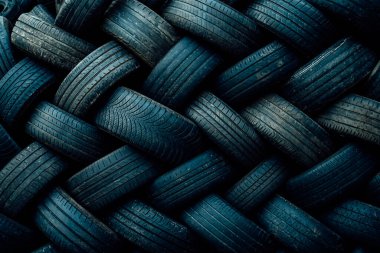 Background of used car tires pile in the tire repair shop yard, Recycle abd reusable ideas. Selective focus, copy space