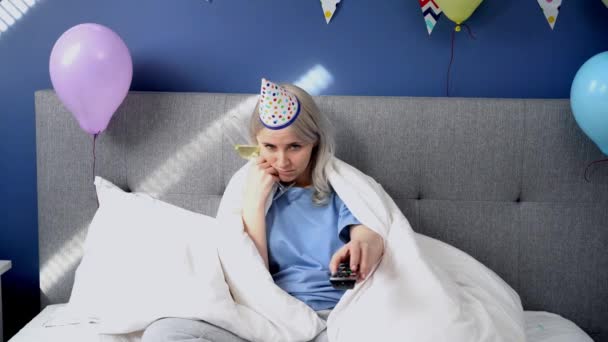 Sad Woman Pajamas Party Cap Drinks Champagne Watches Wrapped Blanket — Stock video