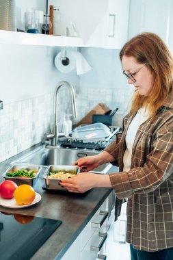 Kilo vermek için sağlıklı bir diyet planı, günlük hazır yemek menüsü. Artı boy kadın, önceden pişirilmiş beslenme çantası, mutfak terazisinde yemeye hazır. Sağlıklı yemekle dengeli porsiyon. Pişirme öncesi konsept.