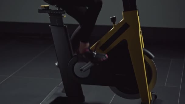 Female Engaged Fitness Spin Bike Performs Aerobic Endurance Training Simulator — Stock Video