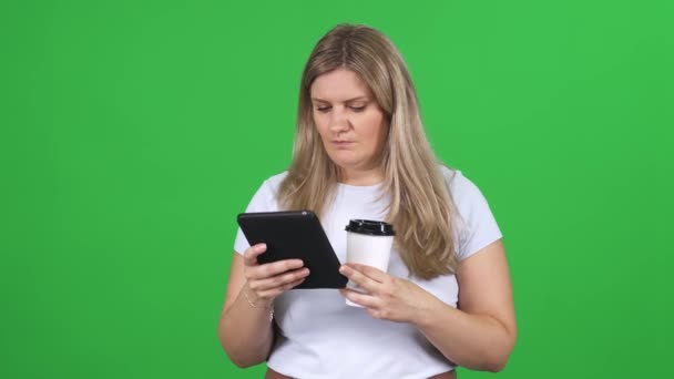 Woman Standing Chromakey Background Using Screen Tablet Drinks Coffee Texting — Stock Video