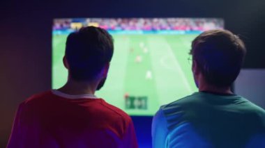 Esports, gençler bir oyun konsolunda video oyunu oynuyor, iki oyuncunun karşılaşması, bir futbol turnuvasında siber sporcular, arka görüş..