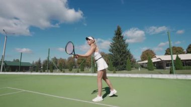 Profesyonel tenisçi topa raketle vurur, tenis kortunda antrenman yapar, kadın tenis maçında top oynar, 4k ağır çekimde..
