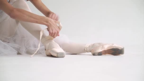 Young Woman White Tutu Sits Floor Ties Ribbons Her Pointe — Stock Video