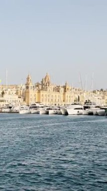 Malta, Valletta - 22 Mart 2025: Eski kasabanın körfezindeki liman ve yatların güzel manzarası, mimari ve yat limanı, dikey video manzarası, koy manzarası.