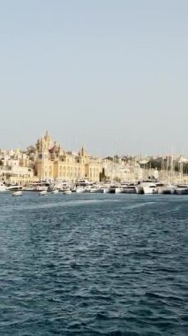 Malta, Valletta - 22 Mart 2025: Eski kasabanın körfezindeki liman ve yatların güzel manzarası, mimari ve yat limanı, dikey video manzarası, koy manzarası.