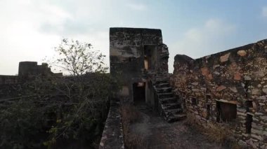 Achrol Fort, a decaying and abandoned fortress near Jaipur, Rajasthan, with crumbling walls and a haunting atmosphere