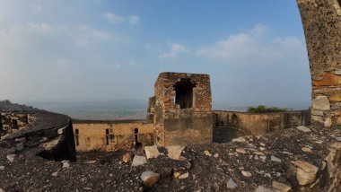 Achrol Fort, a decaying and abandoned fortress near Jaipur, Rajasthan, with crumbling walls and a haunting atmosphere