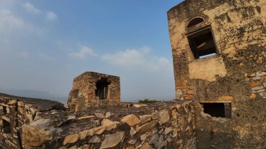 Achrol Fort, a decaying and abandoned fortress near Jaipur, Rajasthan, with crumbling walls and a haunting atmosphere
