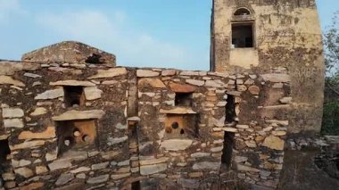 Achrol Fort, a decaying and abandoned fortress near Jaipur, Rajasthan, with crumbling walls and a haunting atmosphere