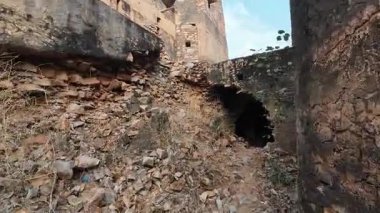 Achrol Fort, a decaying and abandoned fortress near Jaipur, Rajasthan, with crumbling walls and a haunting atmosphere