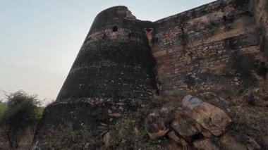 Achrol Fort, a decaying and abandoned fortress near Jaipur, Rajasthan, with crumbling walls and a haunting atmosphere