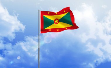 Grenada bayrağı dalgalanır parlak mavi gökyüzünde