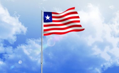 Liberya bayrağı dalgalanır parlak mavi gökyüzünde