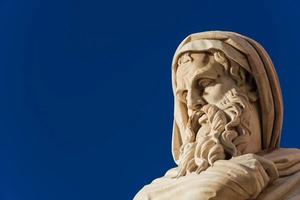 Old and wise man statue. A neoclassical marble statue erected in 1824  in Rome People\'s Square (with blue sky and copy space)
