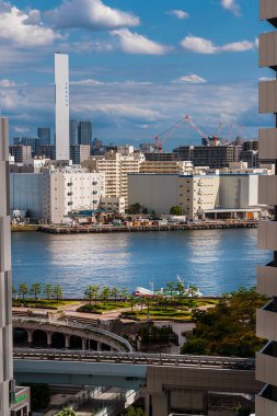 Tokyo, JAPAN, OCTOBER 21, 2023 - Harumi modern buildings in Tokyo Bay Area from Takeshiba Port city panoramic terrace clipart