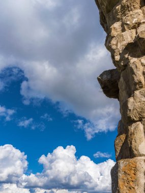 Ancient roman wall with clouds as background clipart