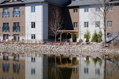 Taştan evlerle dolu nehir ve dinlenmek için sandalyeler.