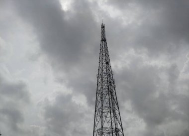 A mobile tower in a cloudy sky background