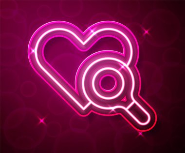 Glowing neon line Medical heart inspection icon isolated on red background. Heart magnifier search.  Vector