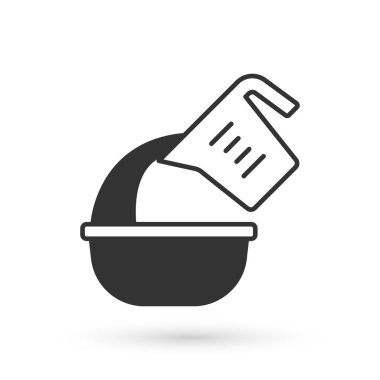 Grey Measuring cup pouring liquid into bowl icon isolated on white background. Plastic graduated beaker with handle. Vector.