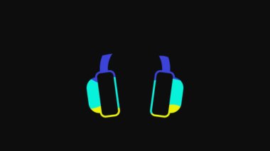 Yellow Headphones icon isolated on black background. Earphones. Concept for listening to music, service, communication and operator. 4K Video motion graphic animation.