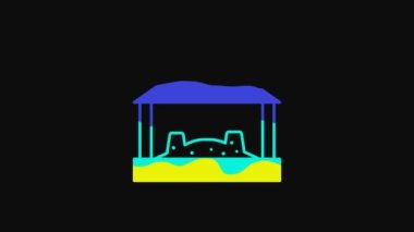 Yellow Sandbox for kids with sand and umbrella icon isolated on black background. 4K Video motion graphic animation.