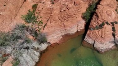 Güney Utah 'taki Sand Hollow Reservoir' ın kırmızı kayalıklarına ve renkli suyuna bakan hava manzarası.