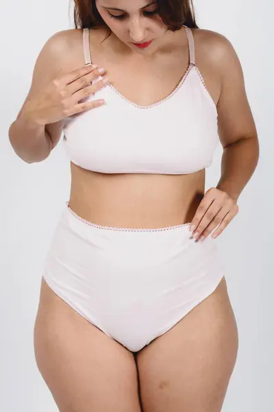 stock image close-up, vertical image of woman in white underwear posing for social networks of feminine concepts, natural bodies and skin and body care.