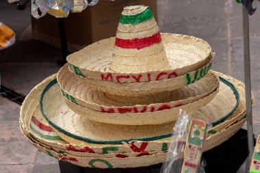 A collection of Mexican hats with the word Mexico written on them. Historic center of Queretaro City, decorations and traditions to celebrate Mexico's Independence Day, colonial architecture, alleys and facades