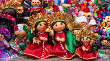 A collection of dolls with different colors and designs. The dolls are arranged in a row. Historic center of Queretaro City, decorations and traditions to celebrate Mexico's Independence Day, colonial architecture, alleys and facades