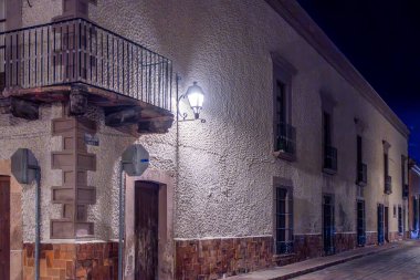 A building with a balcony and a sign that says 