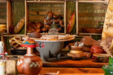Oaxacan crafts A table full of colorful pottery and bowls. The table is covered with various items. Historic center of Queretaro, colonial architecture, decorations for the celebration of Mexico's Independence Day.