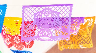 Duvarda çiçek desenli renkli bir pankart asılı. Sancak kağıttan yapılmıştır. Queretaro 'nun tarihi merkezi, sömürge mimarisi, Meksika' nın Bağımsızlık Günü kutlamaları için dekorasyonlar.