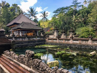 Inside a Hindu temple in Bali, with a tank full of fish clipart